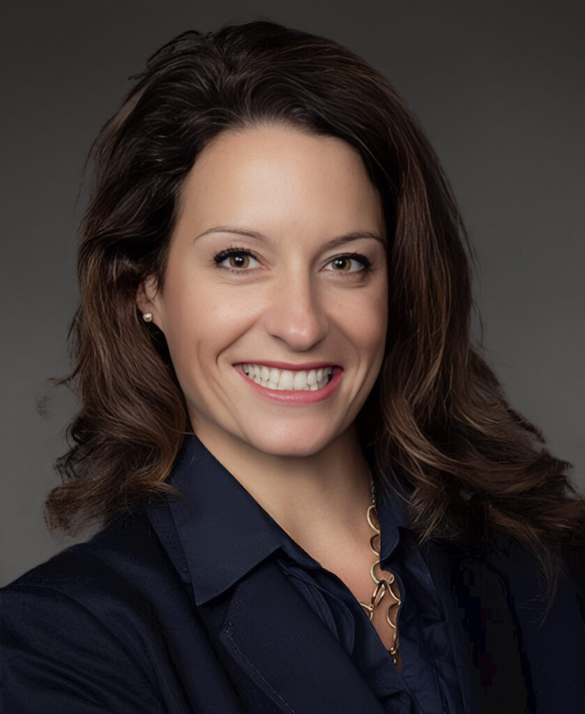 Professional headshot of Karla Goins, a member of the Phluence leadership team, smiling against a neutral studio background.